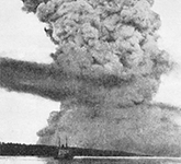 Black-and-white photograph of a large smoke plume after the collision between the ships Mont Blanc and Imo, resulting in the Mont Blanc exploding in the Halifax Harbour.