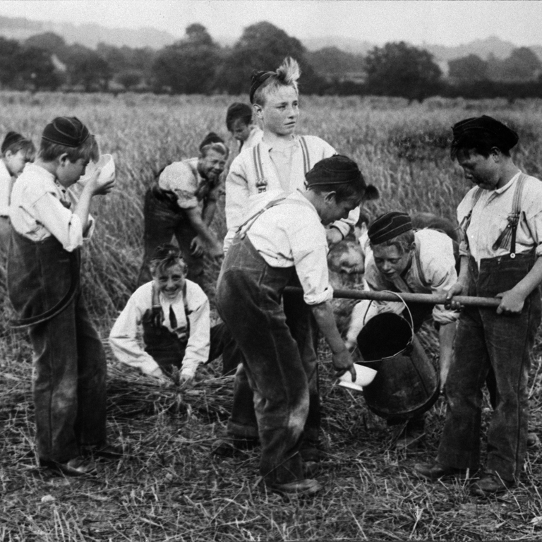 Group of boys working in a field at the Philanthropic Society Farm School