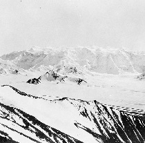 Black and white photograph of a snow-covered mountain.