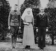 Black and white photograph of a Nursing Sister beside two soldiers